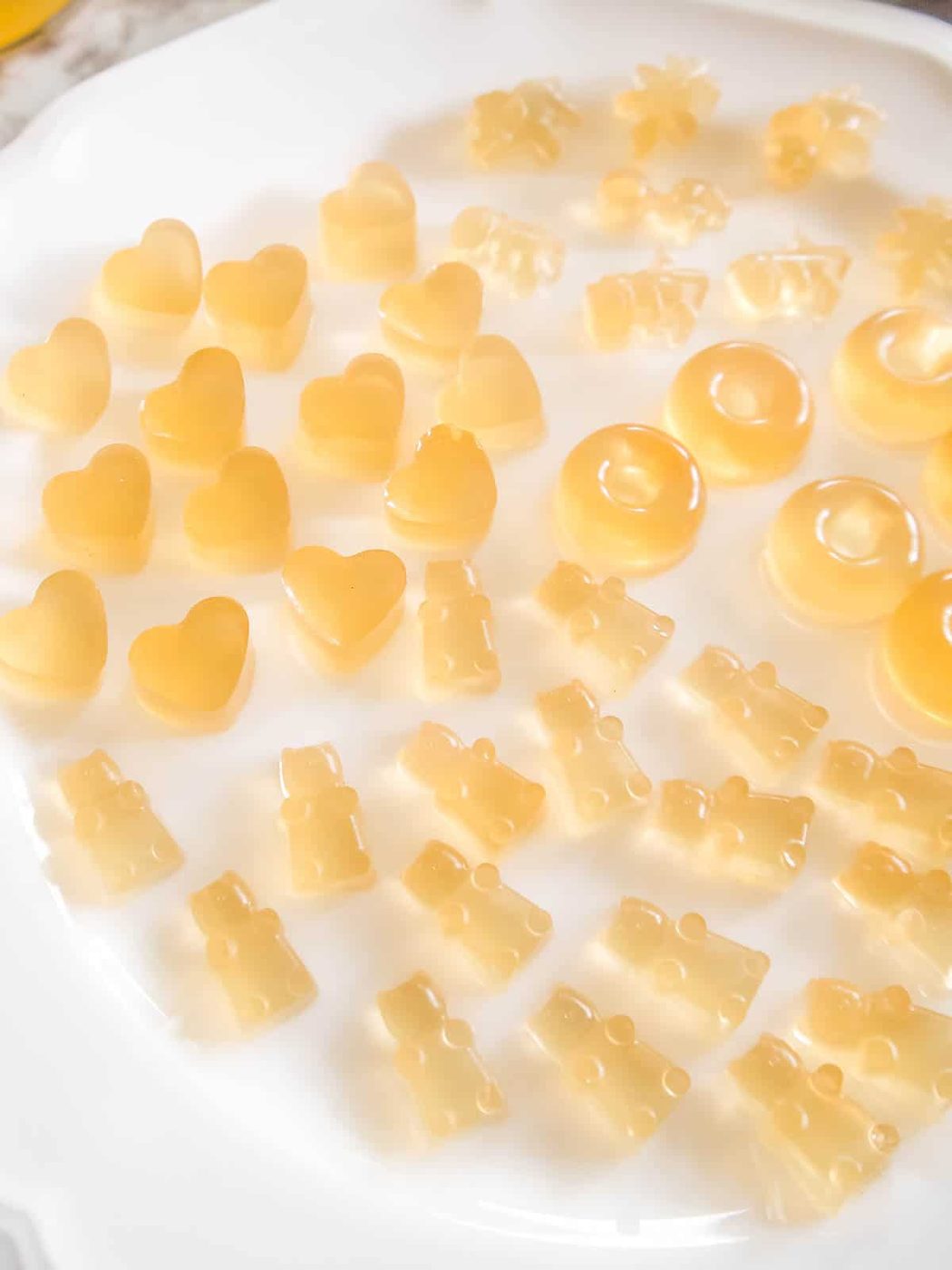 Apple juice gummies on a plate.