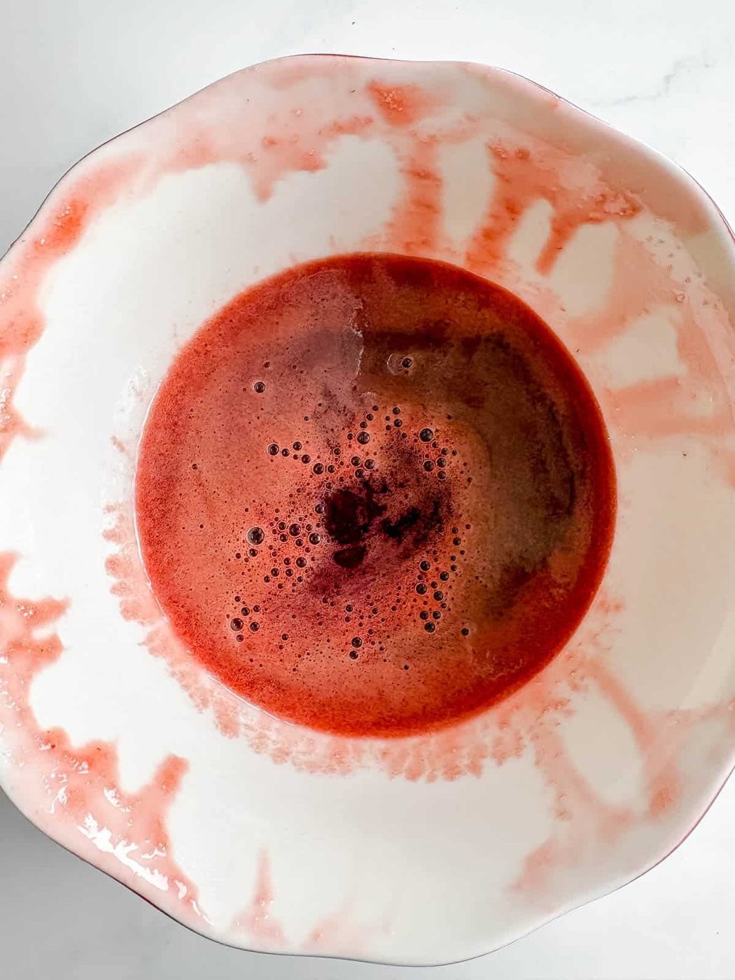 Strawberry syrup in a bowl.