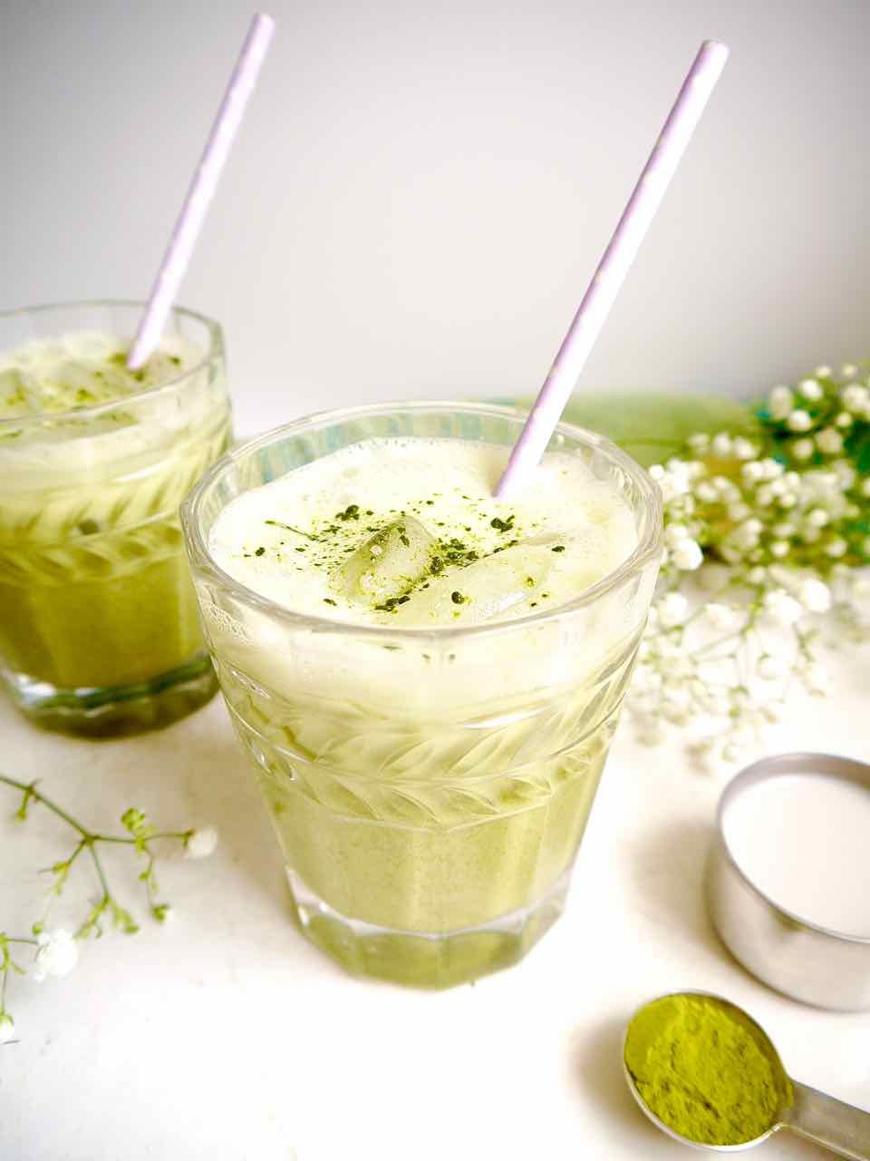 A glass of iced almond milk matcha latte.