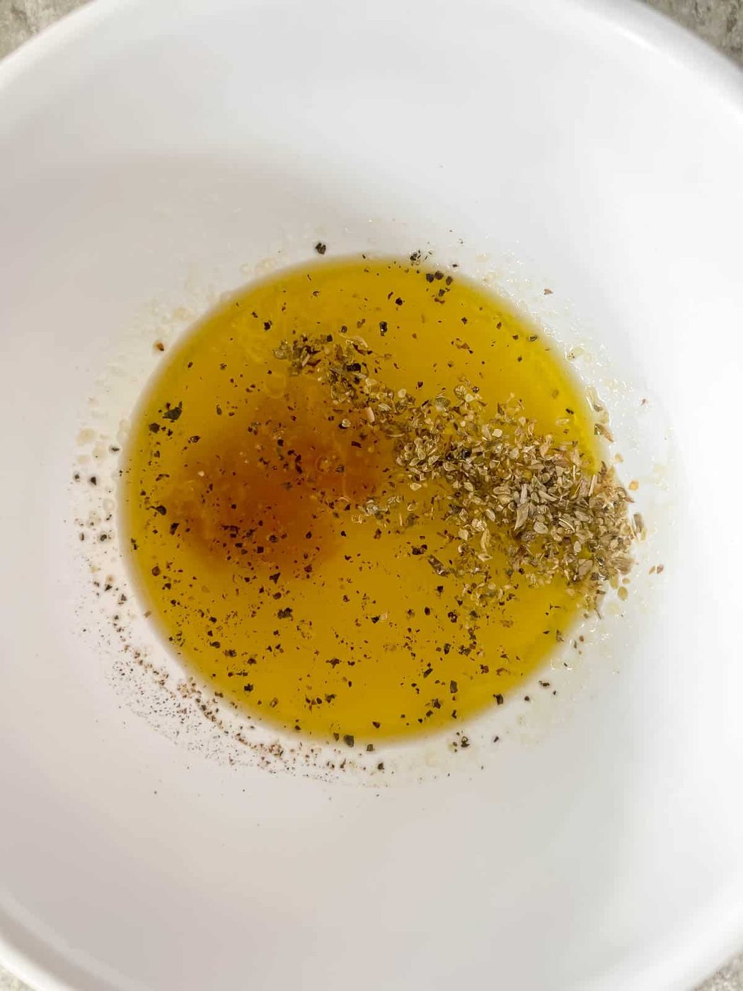 Lemon dressing for arugula salad in a bowl.