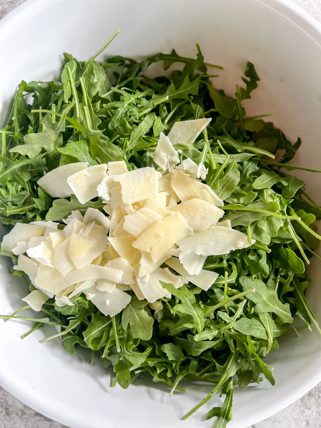 Parmesan added to the arugula.