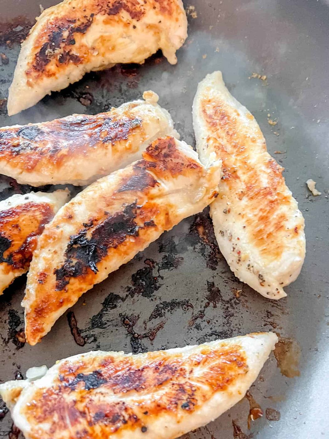 Grilled chicken in a frying pan.