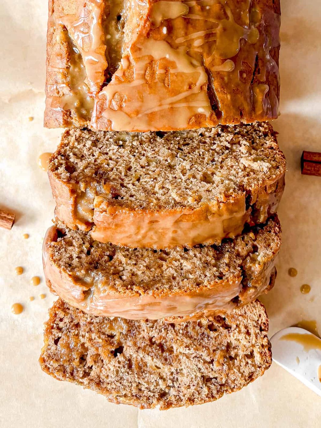 Slices of moist maple banana bread with maple glaze.