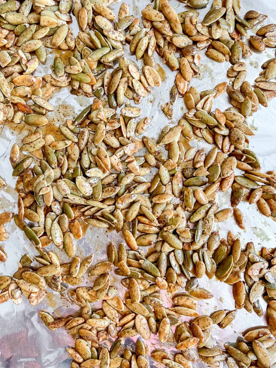Pepitas roasted in the oven on a cookie sheet.