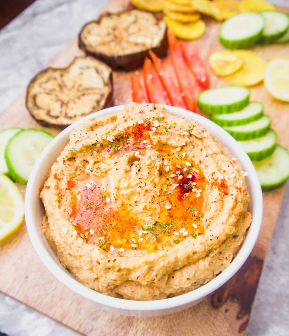 Hummus without chickpeas in a bowl with veggies on the side to dunk into it.