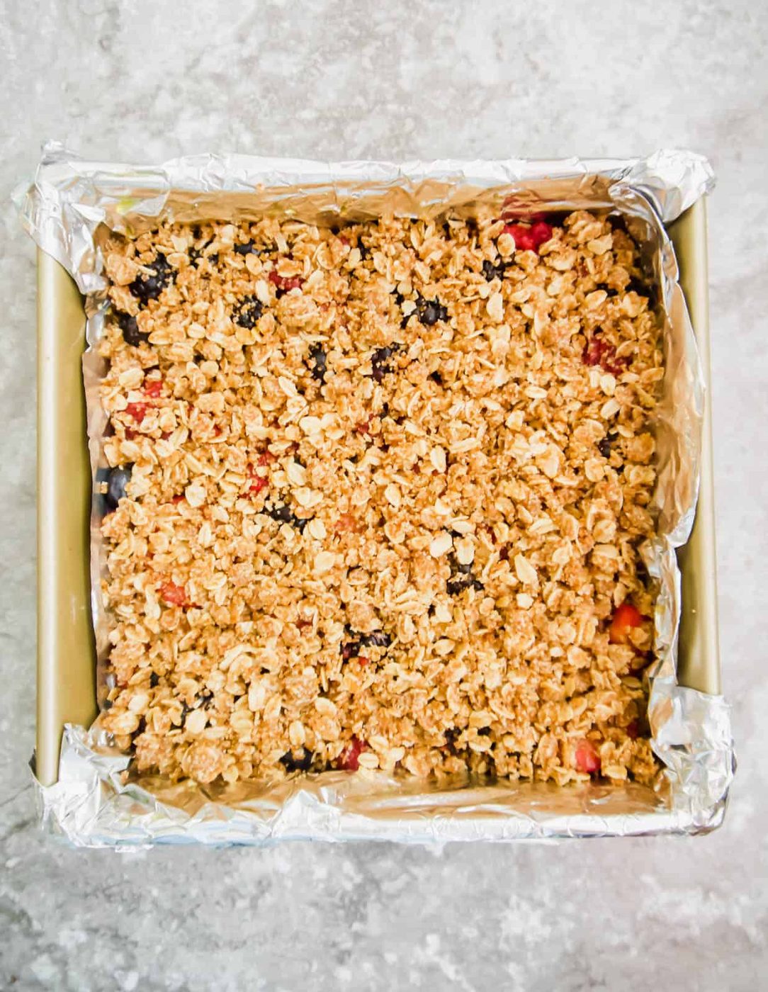 Another oat layer is added on top of the fruit layer.
