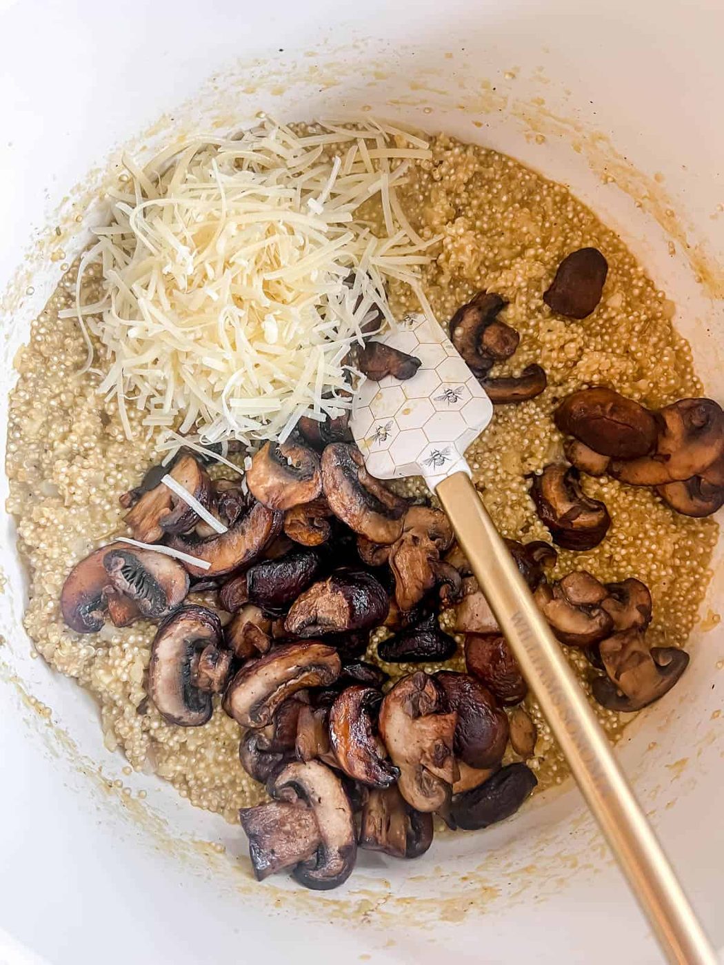Mushroom quinoa risotto in a large pan.