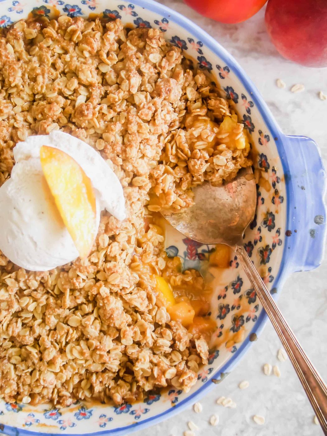 Freshly baked nectarine crisp with ice-cream on top.