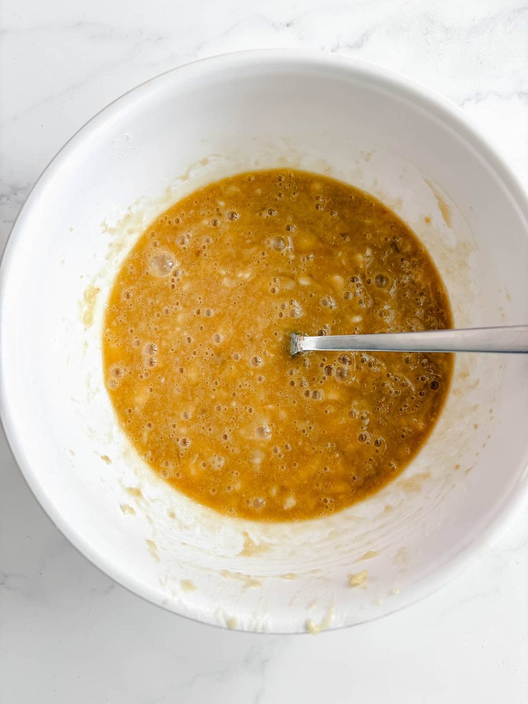 Wet ingredients for olive oil banana bread recipe.
