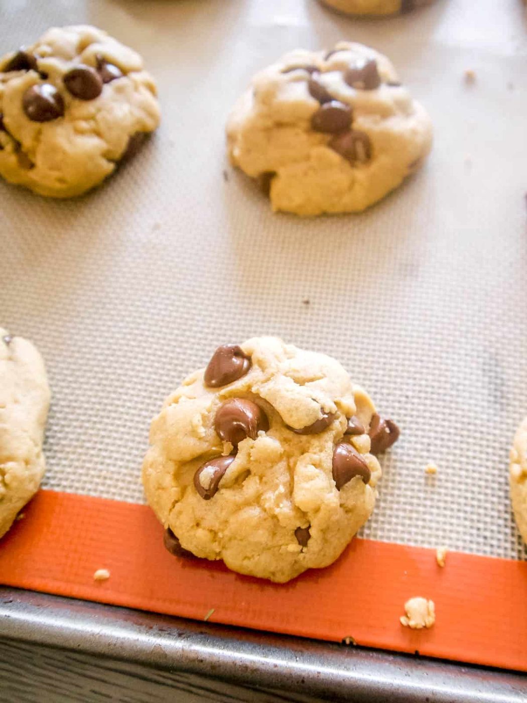 Cookies freshly baked on a cookie sheet.