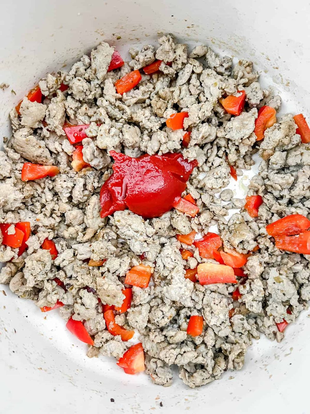 Tomato paste added to the ground turkey.