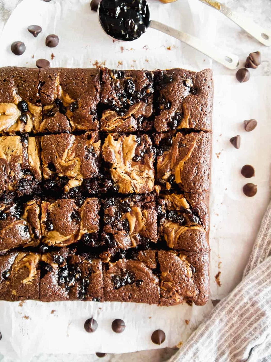 Swirls of almond butter and jelly on top of brownies after baking.