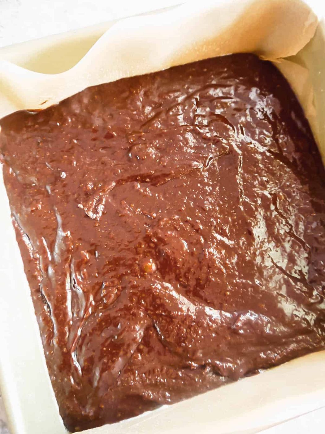 Brownie batter in a baking tin.