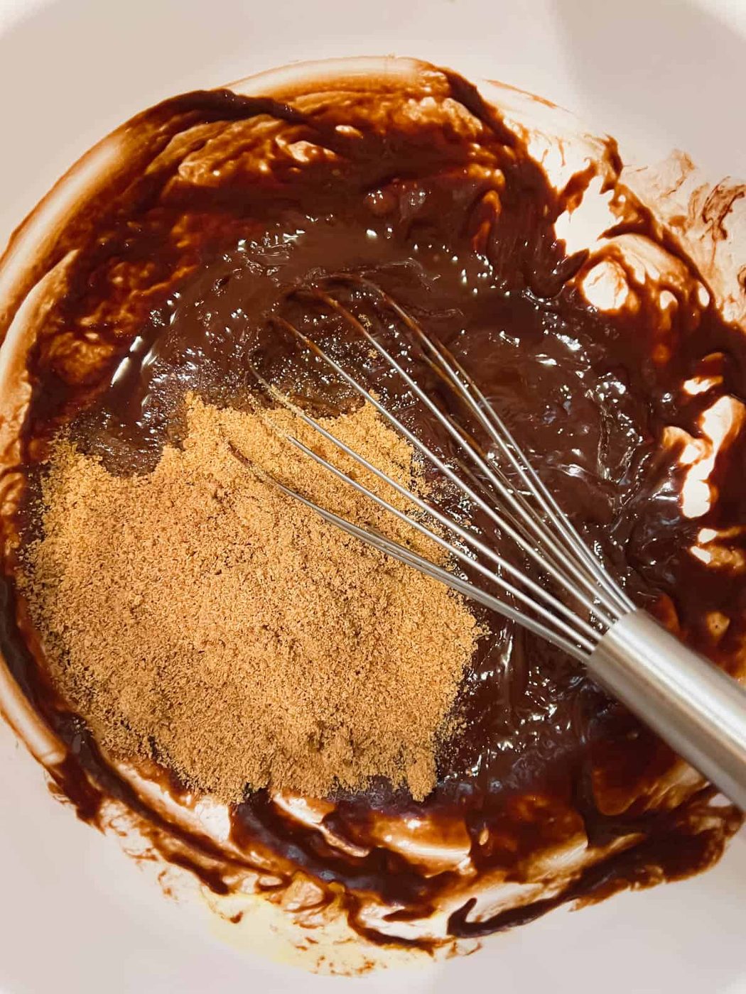 Adding vanilla and coconut sugar to the melted chocolate.
