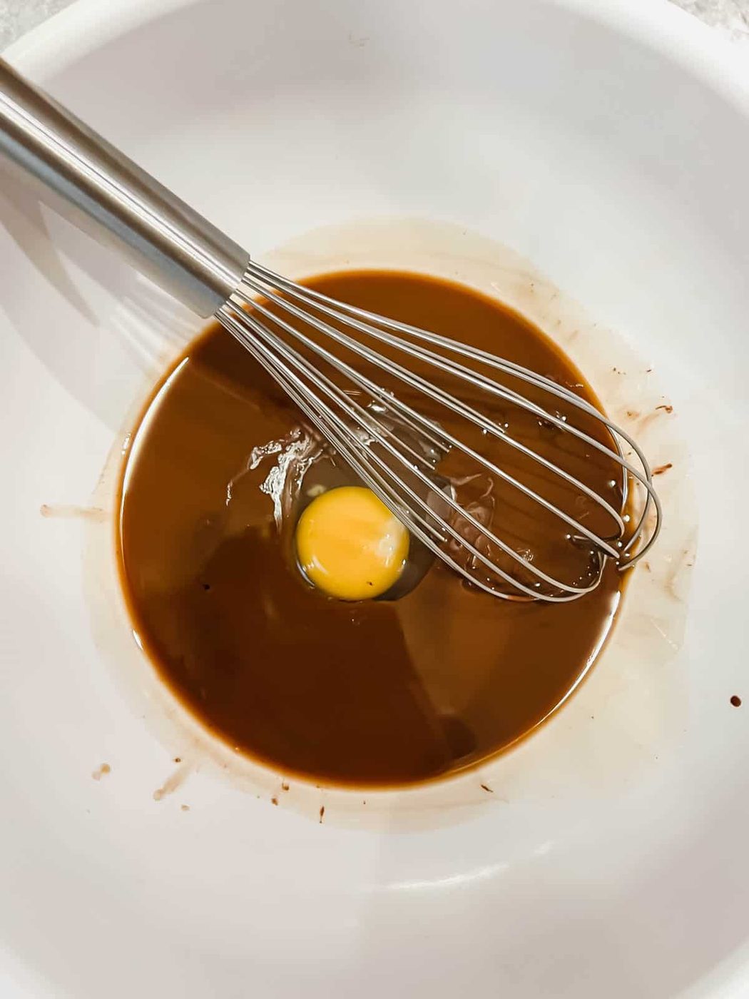 Adding the eggs to the mixture.