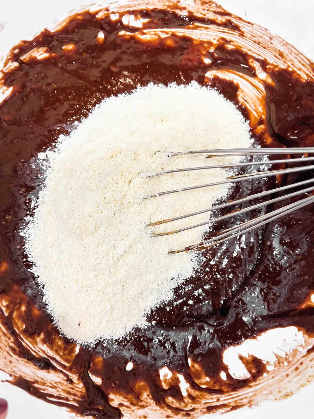 Dry ingredients added to brownie batter.