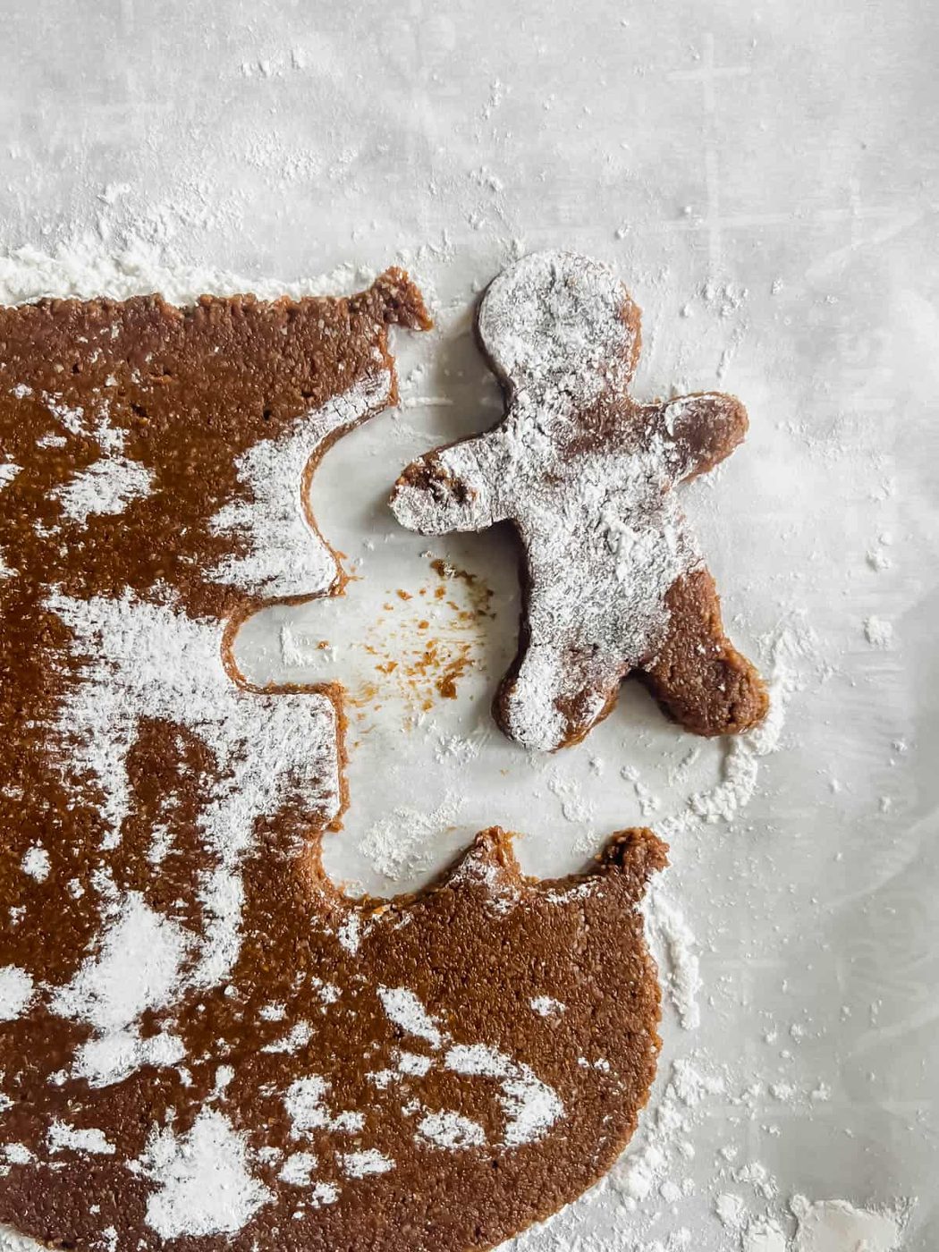 Gingerbread man cut out in the dough.