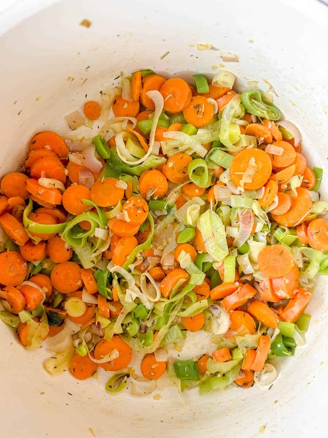 Leeks, garlic, onion and carrot sauteéing in a pot.