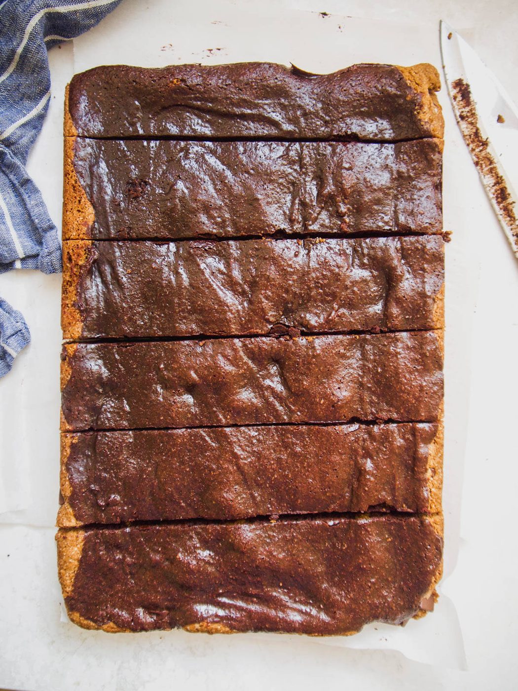 Cutting into paleo brownie cookie bars.