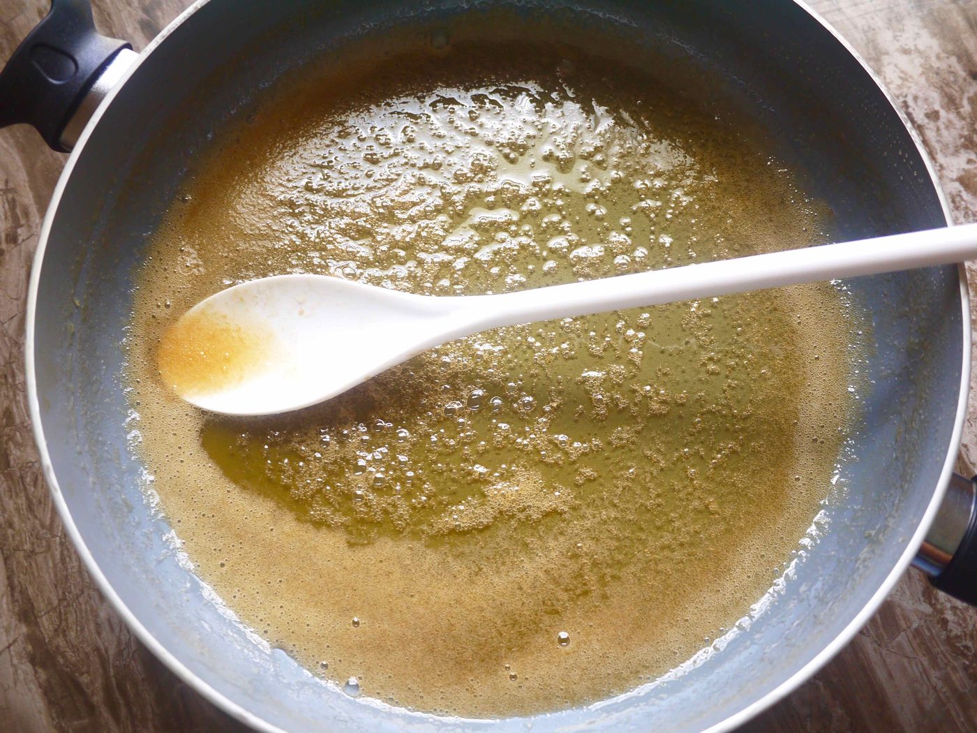 Honey and water in a pan.