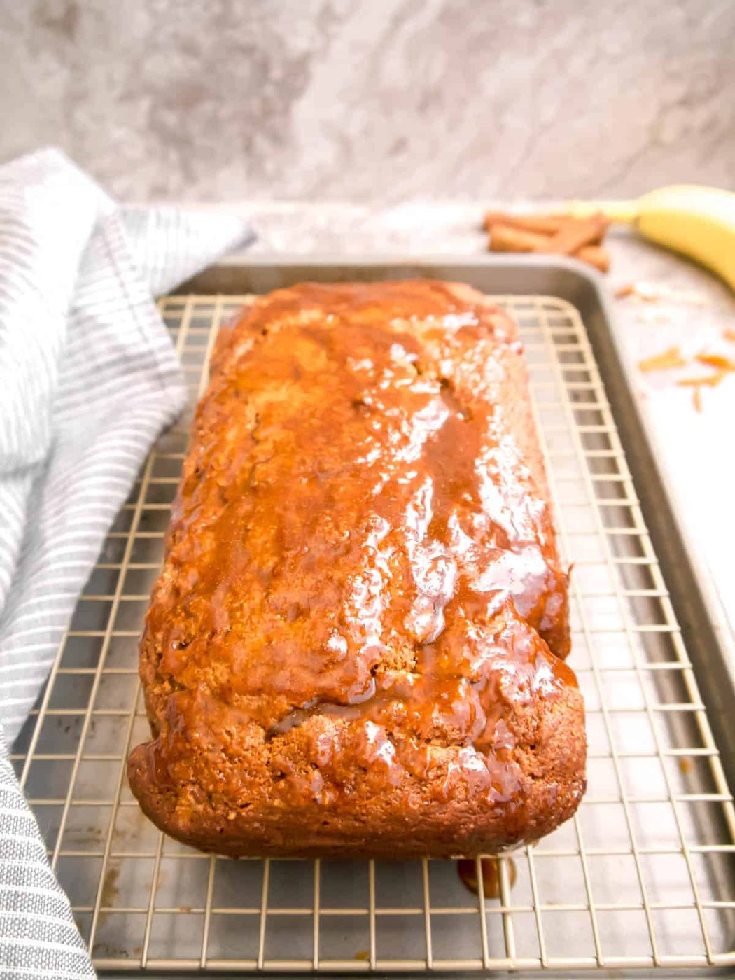 Spreading the frosting on top of the carrot banana bread.