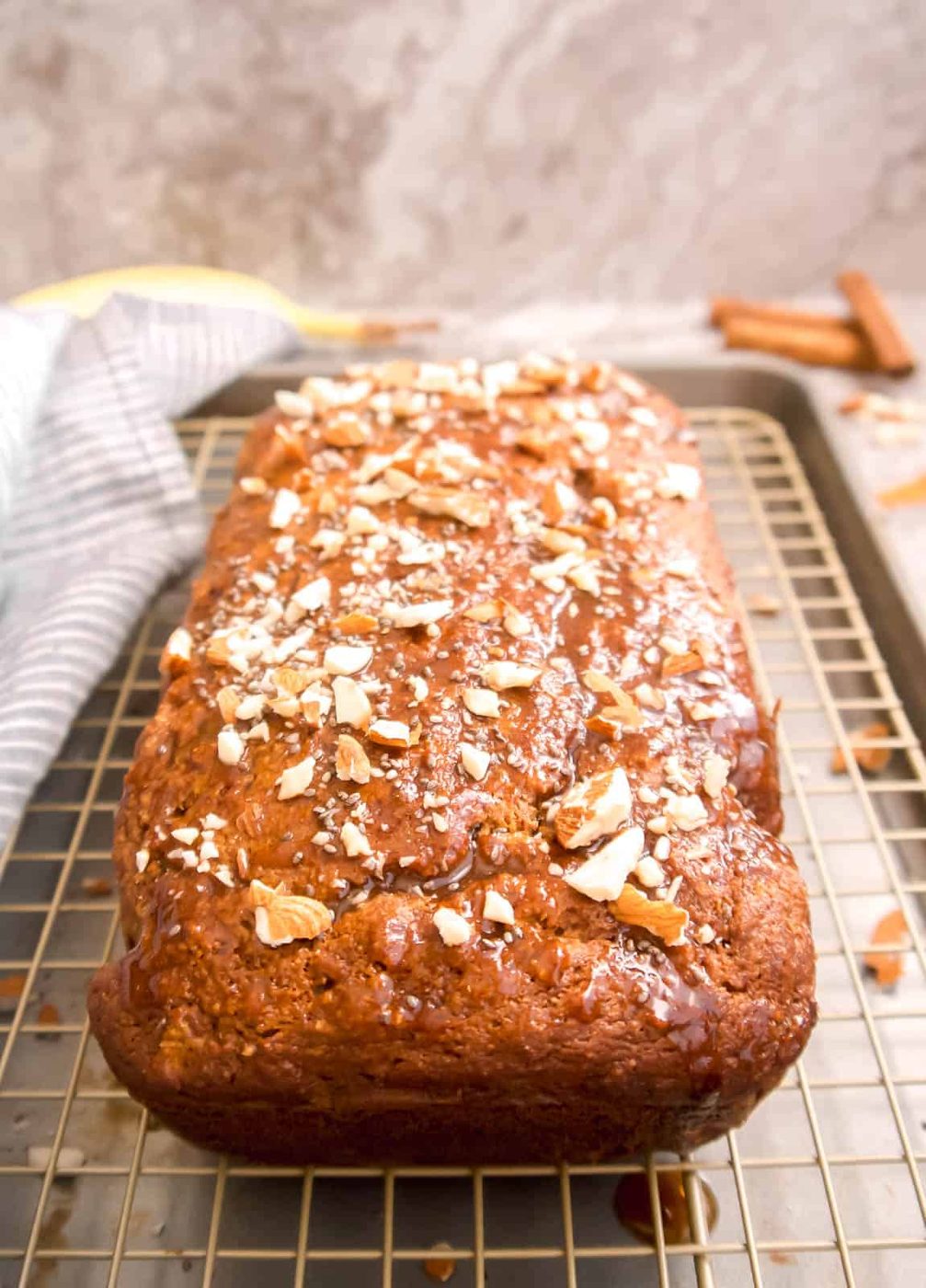 Sprinkling crushed almonds on top of the banana carrot bread recipe.