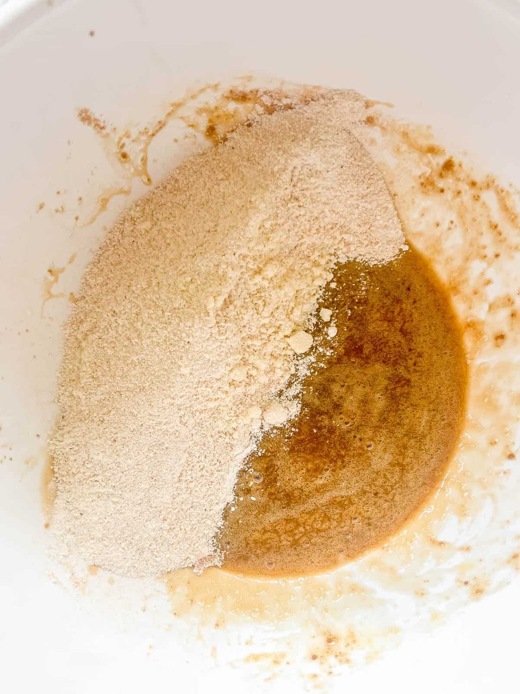 Mixing the wet and dry ingredients in a bowl.