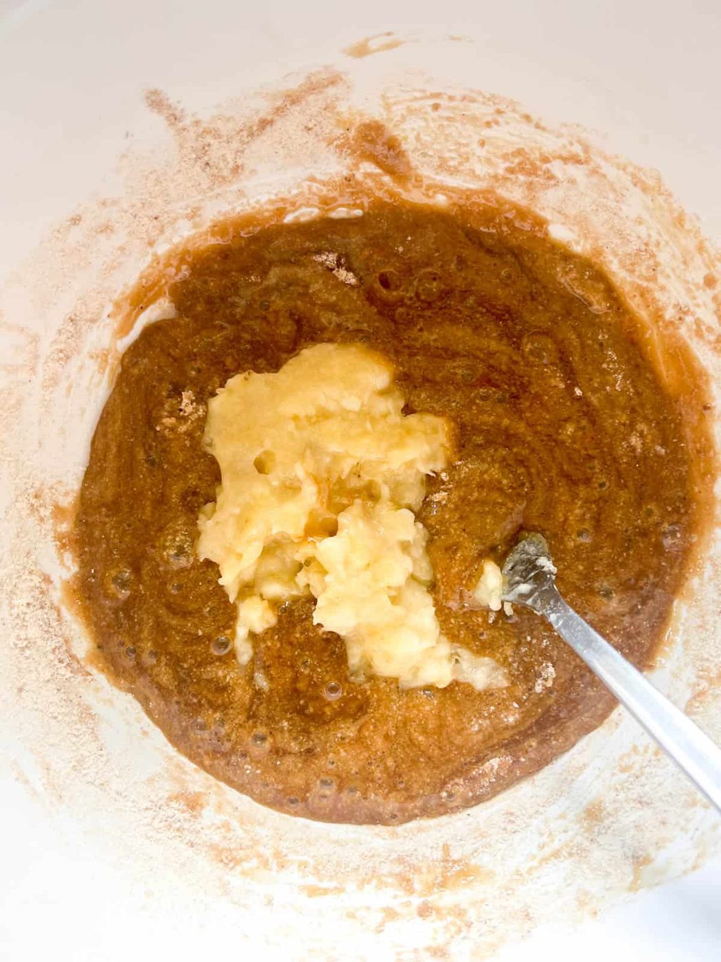Adding bananas to the batter.