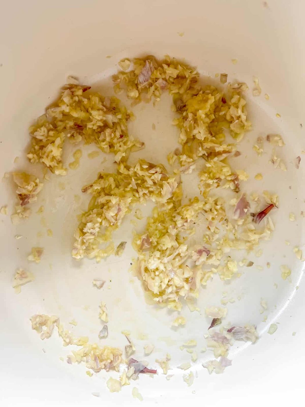 Minced garlic, onion and ginger sautéing in a pan.