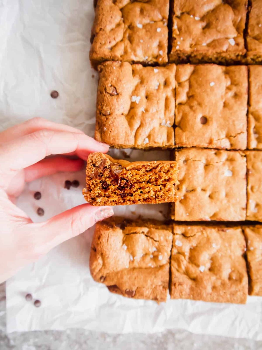 Dairy-free cookie bar in ones hands.