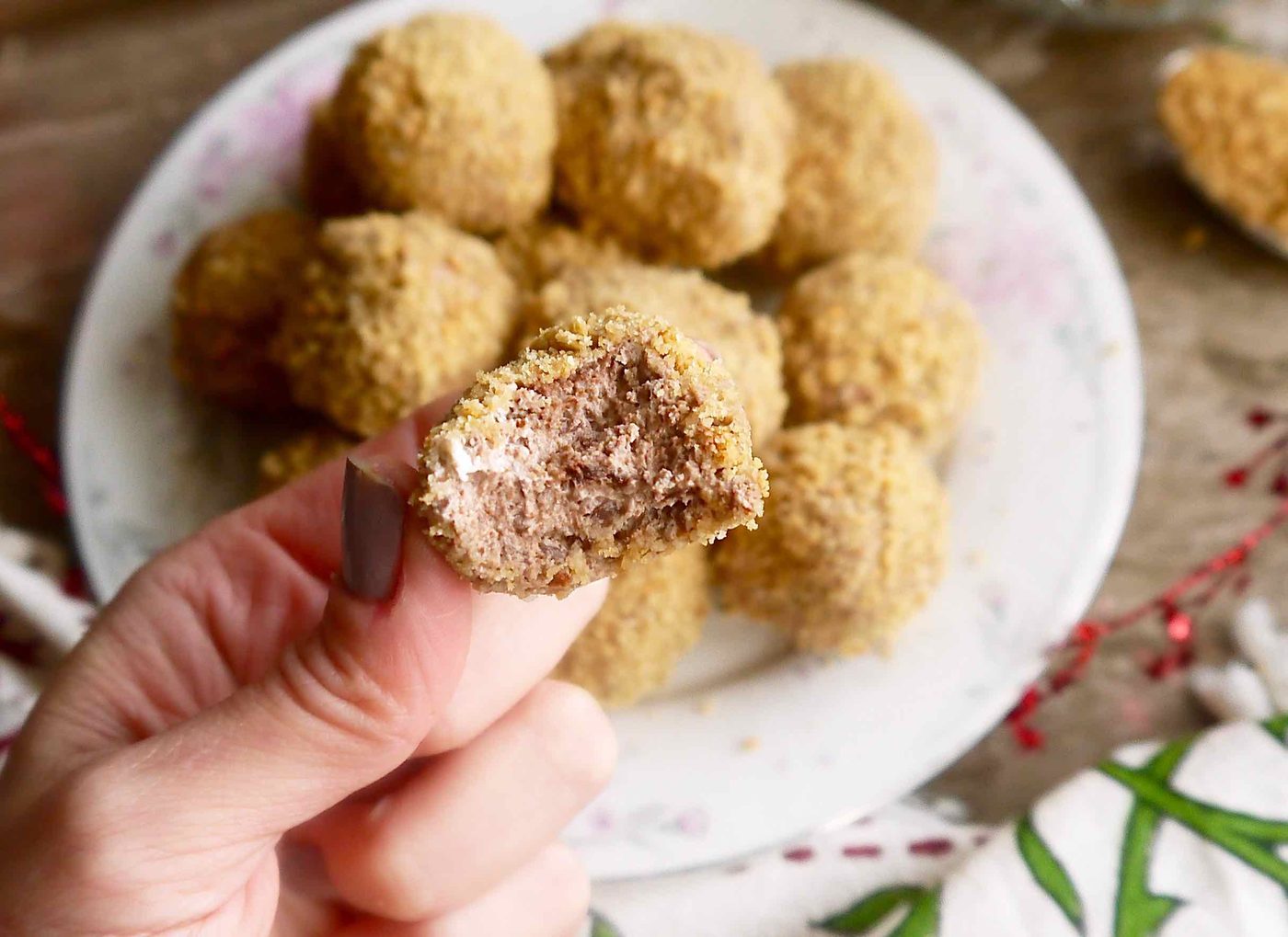 A bite taken out of a chocolate mousse truffle.