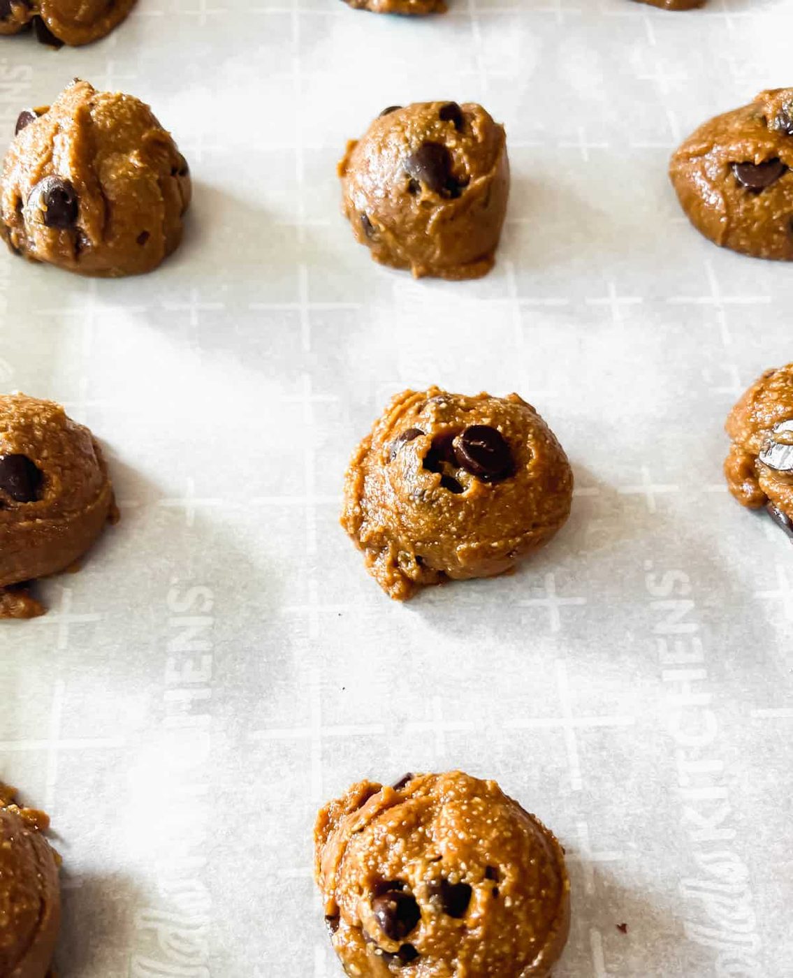 Paleo chocolate chip cookies on a pan before baking.