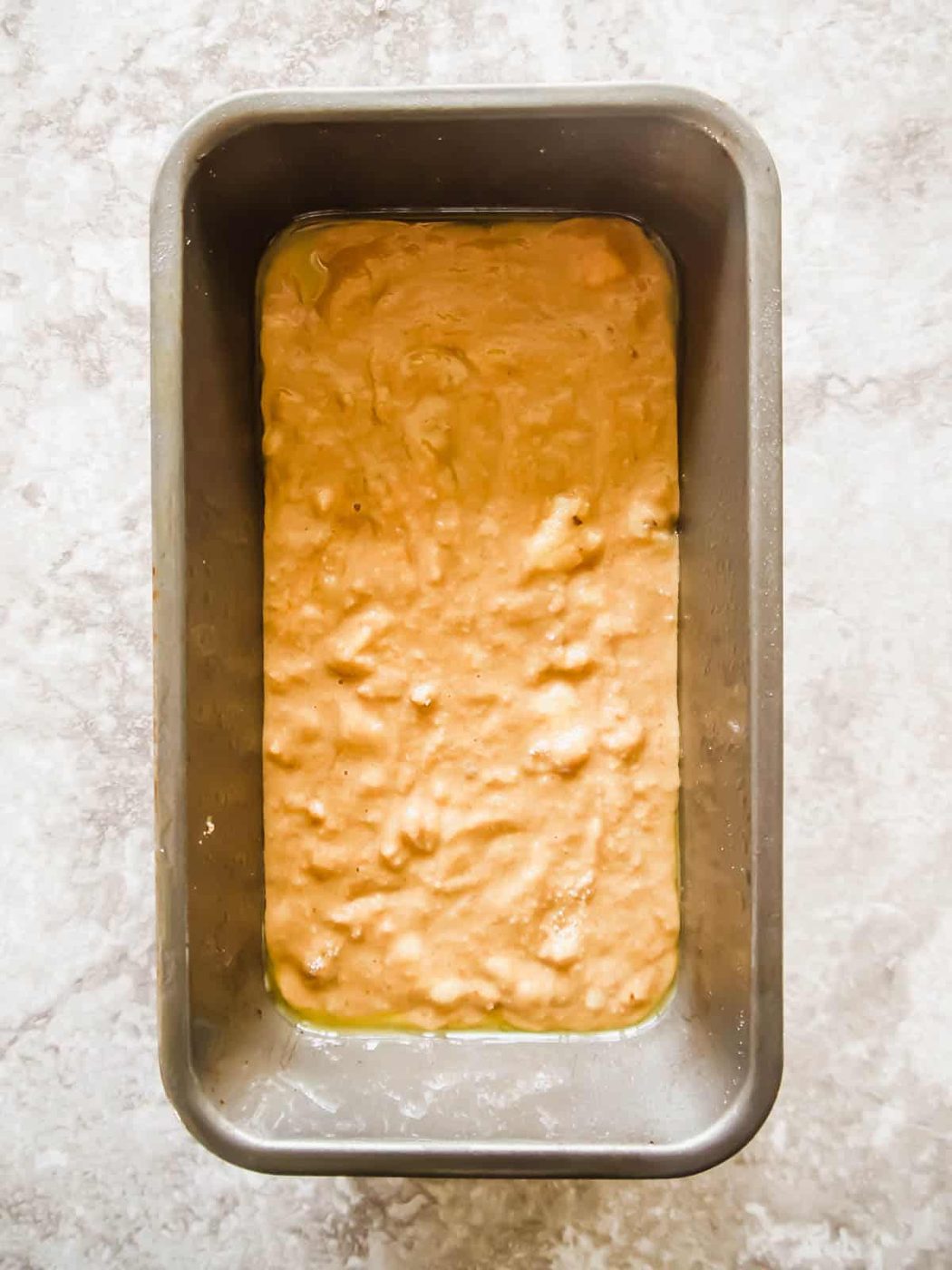 Banana bread coffee cake batter in a loaf tin.