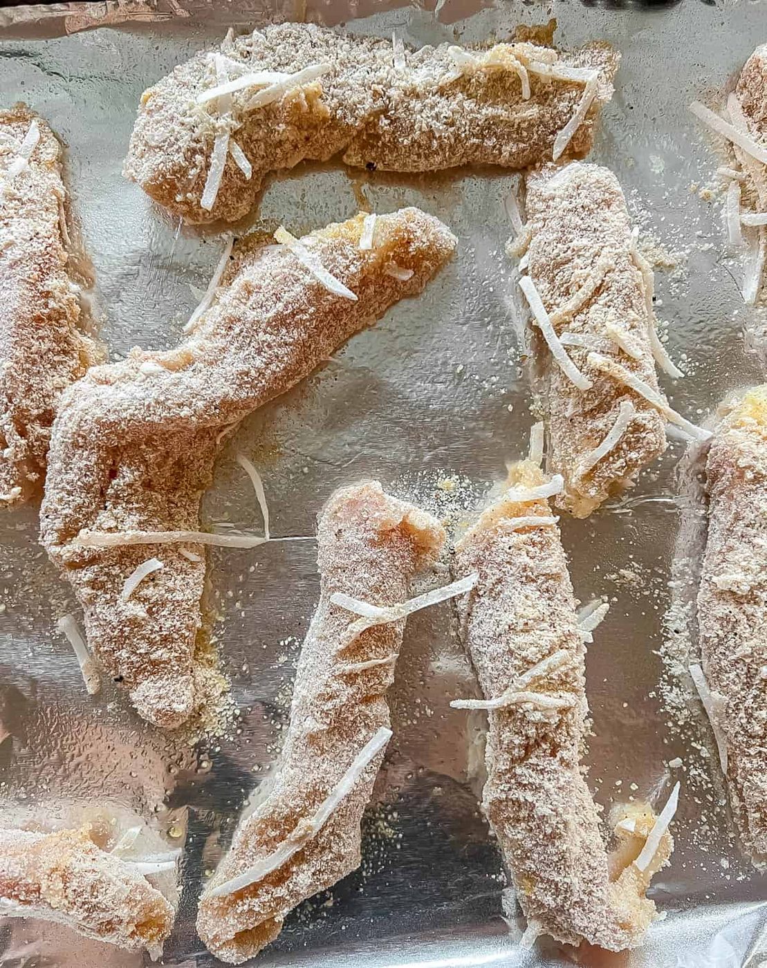 Paleo Chicken tenders on pan prior to baking.