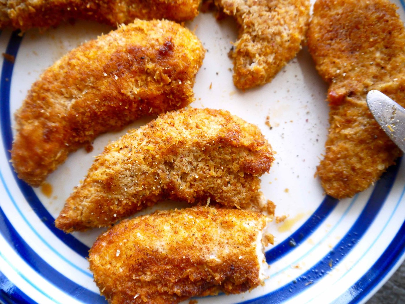 Baked almond flour chicken tenders on a plate.
