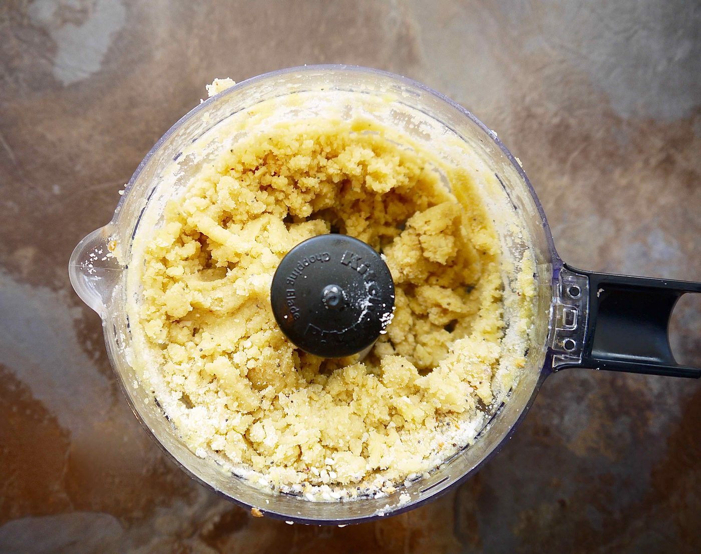 Almond flour cracker dough in a food processor.