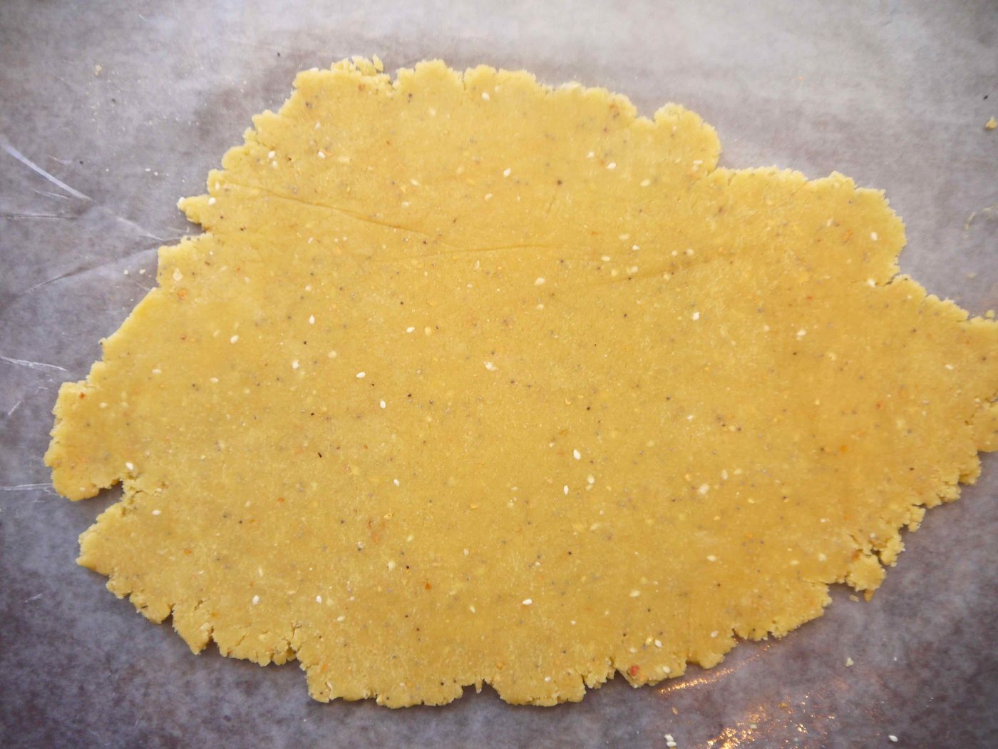 Almond flour cracker dough rolled out flat.