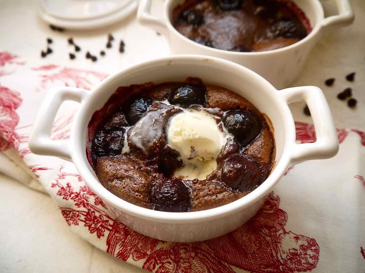 Freshly baked Almond Flour Chocolate Cherry Lava Cakes with ice-cream melting on it.
