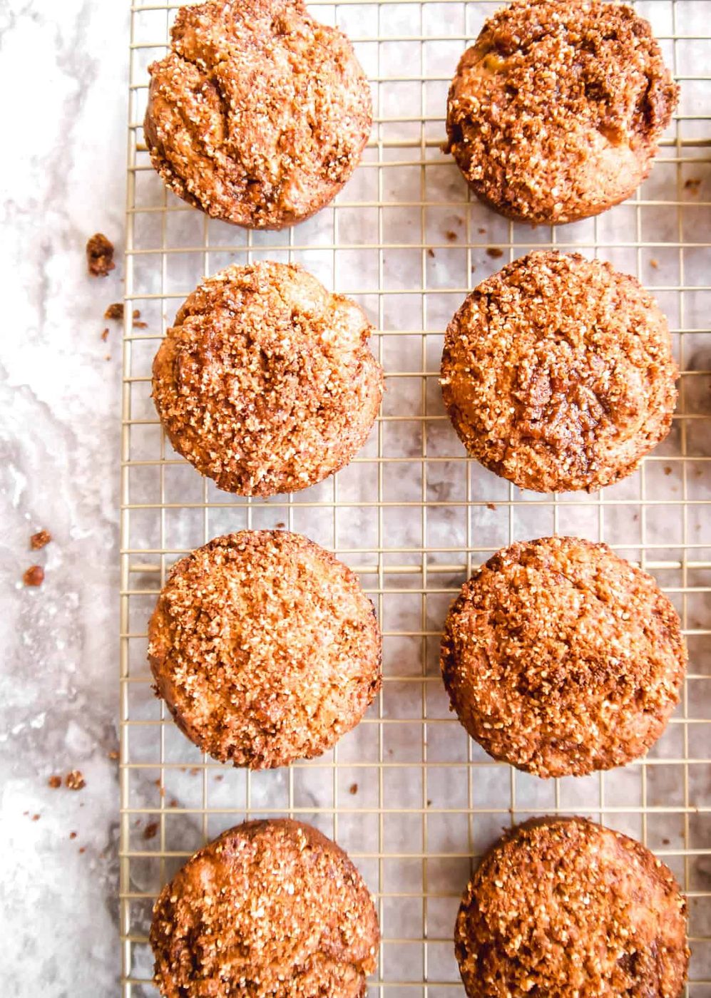 Gluten-free apple cinnamon muffins cooling on a rack.