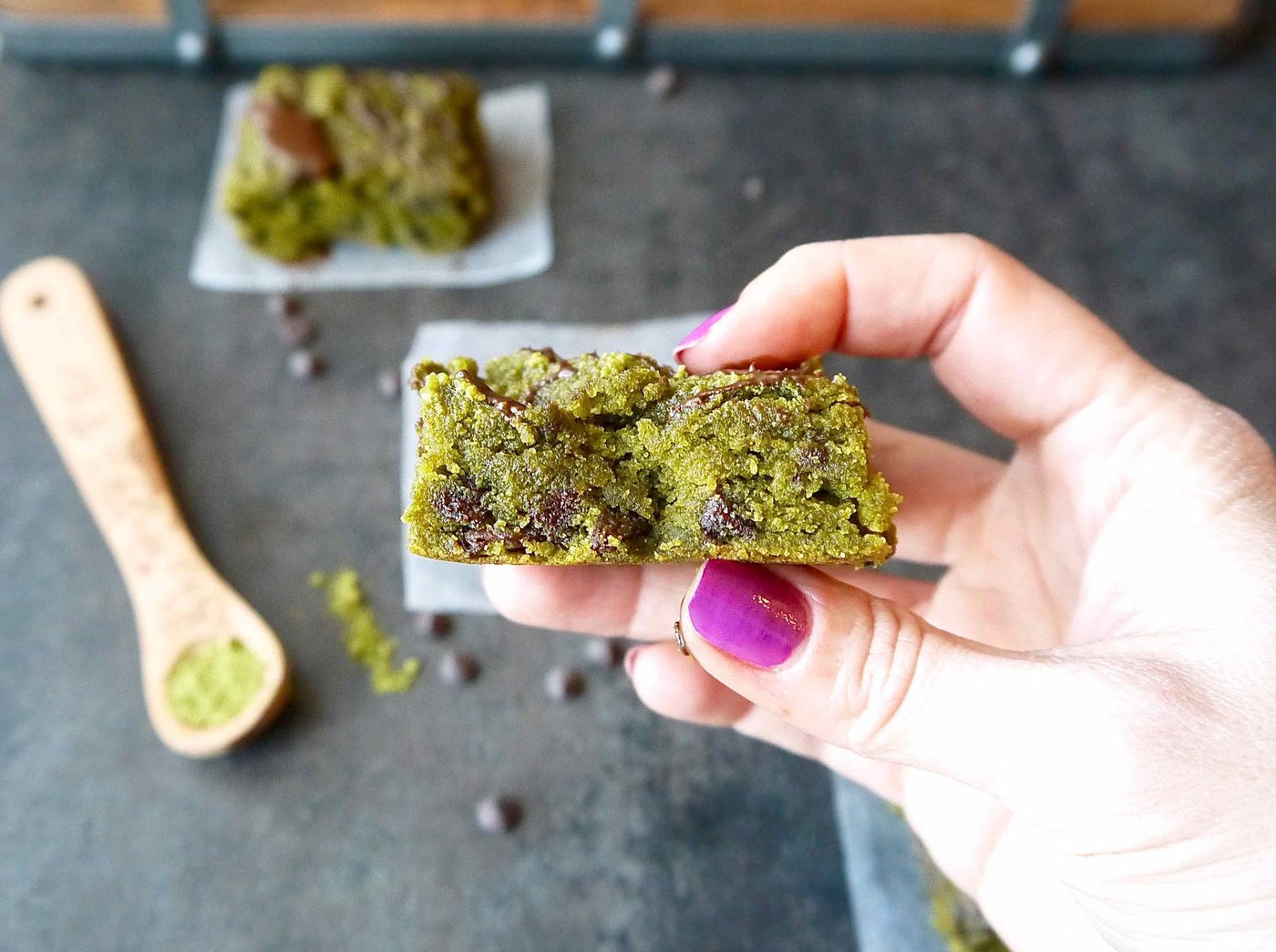 A big bite taken out of a matcha blondie.