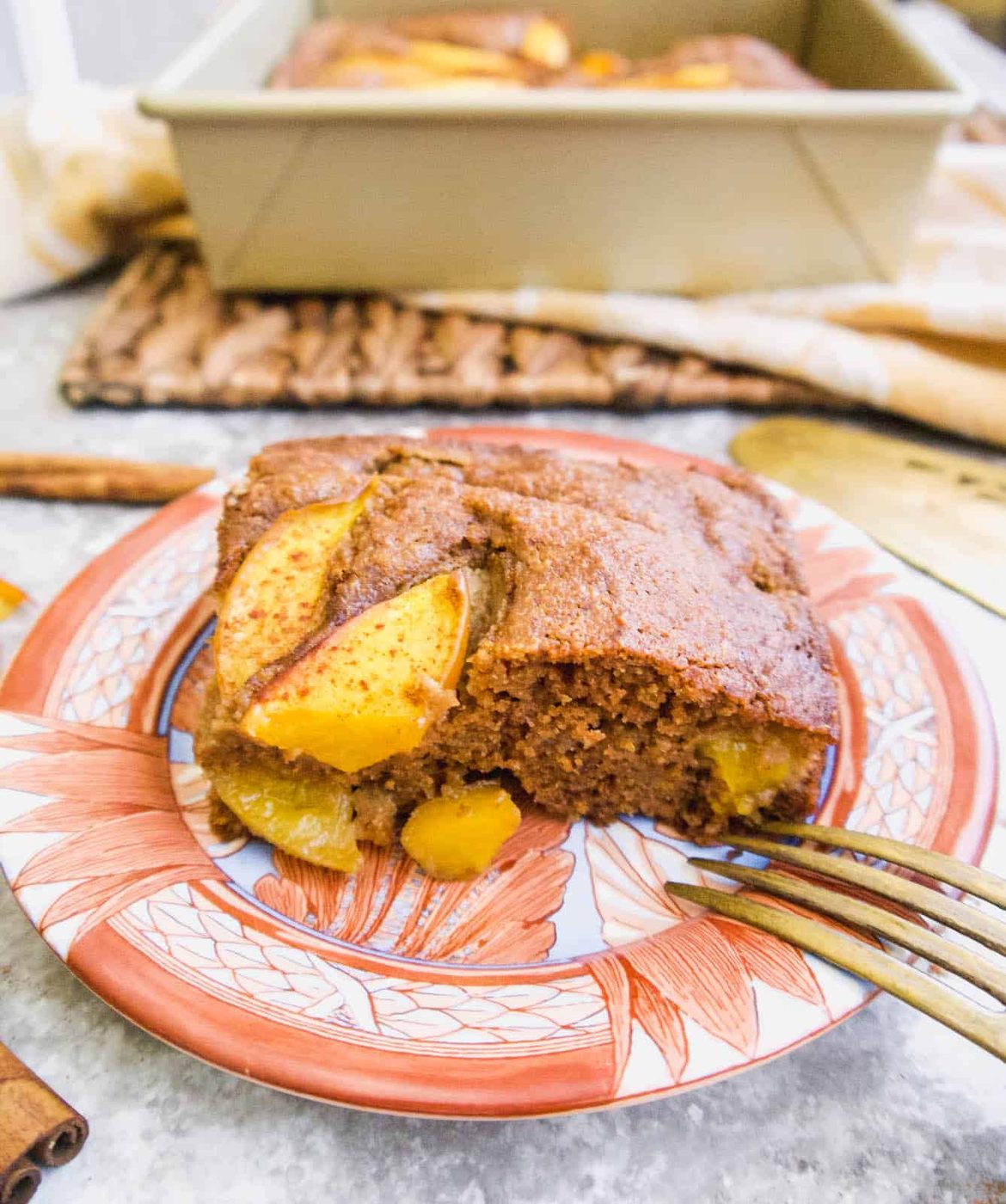 A slice of gluten free nectarine cake on a plate.