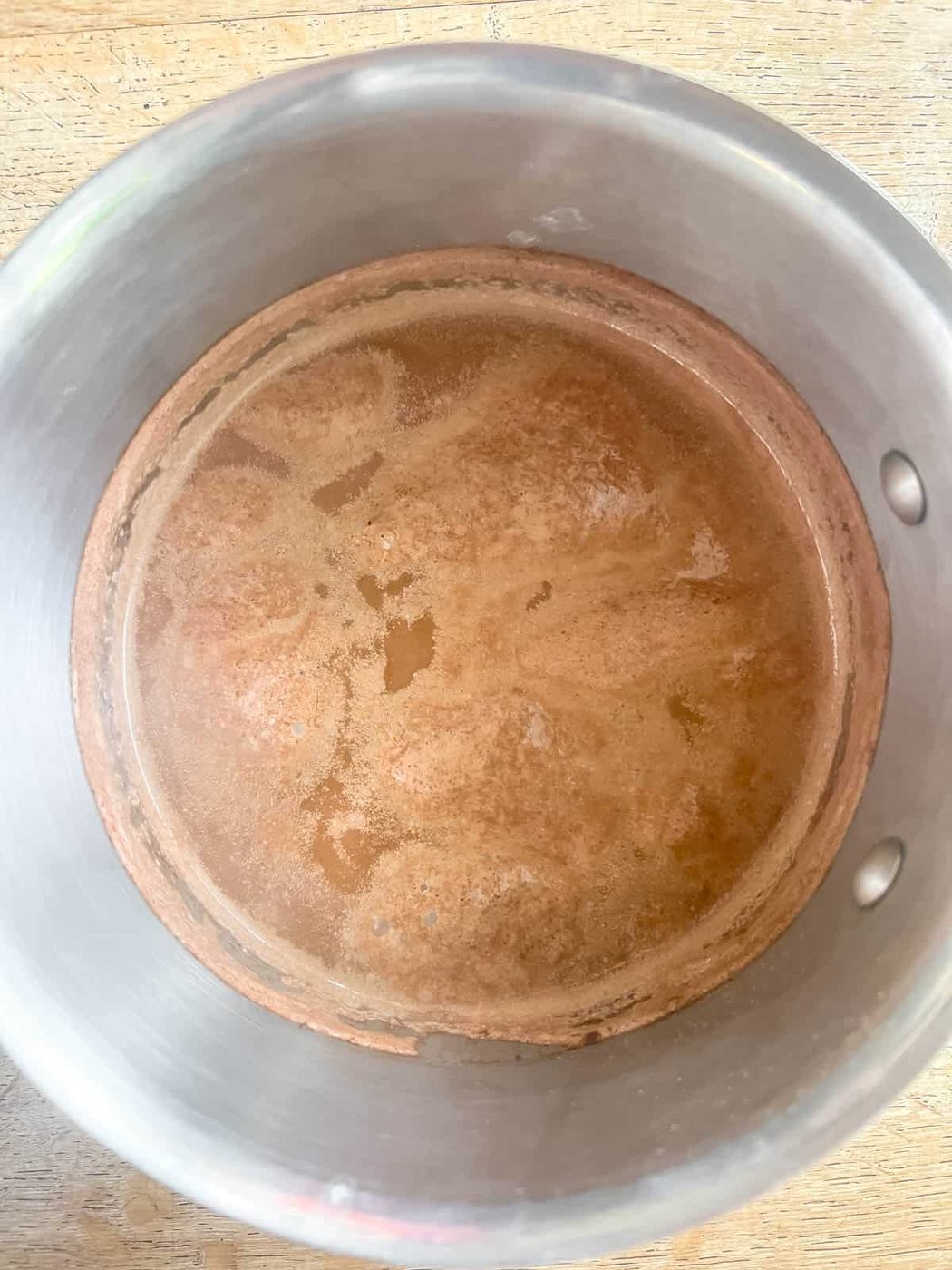 Pumpkin hot chocolate in sauce pan after boiling.