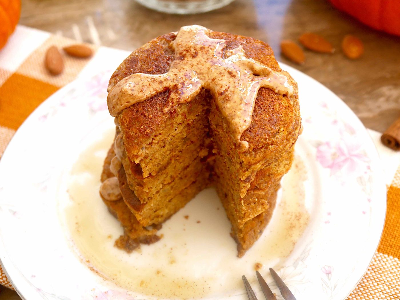 Gluten-free pumpkin pancakes with almond butter on top.