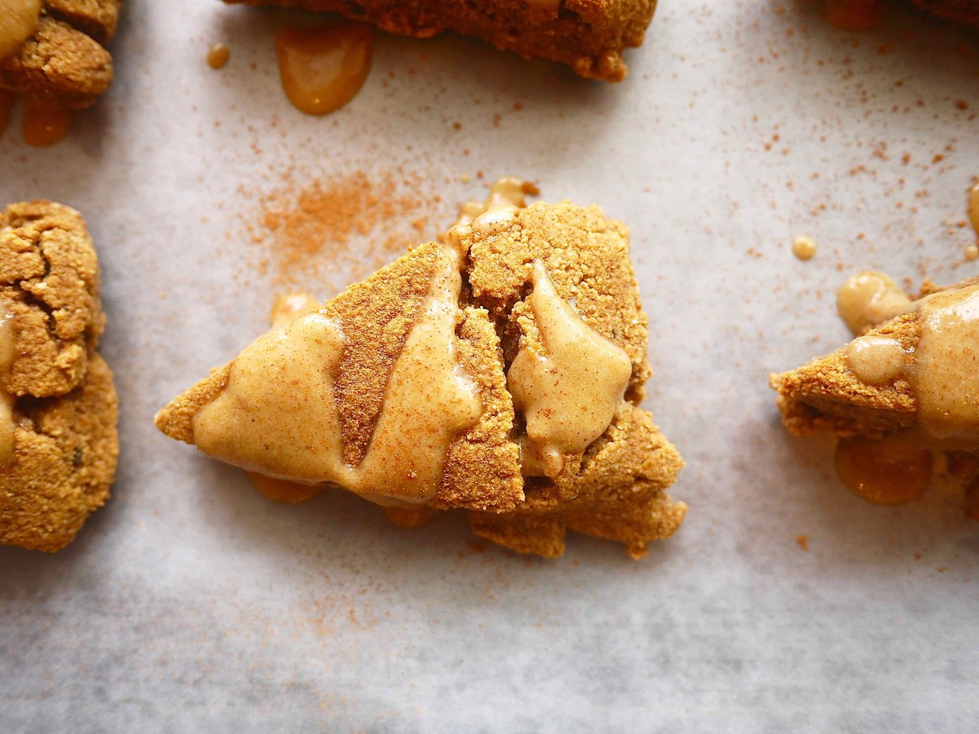 Pumpkin gluten-free scones with frosting on top.