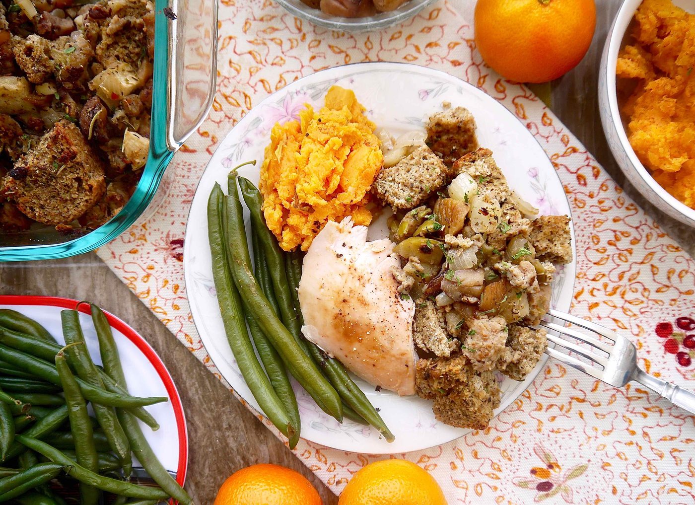 Paleo sausage stuffing on a plate with turkey, mashed potatoes and green beans.