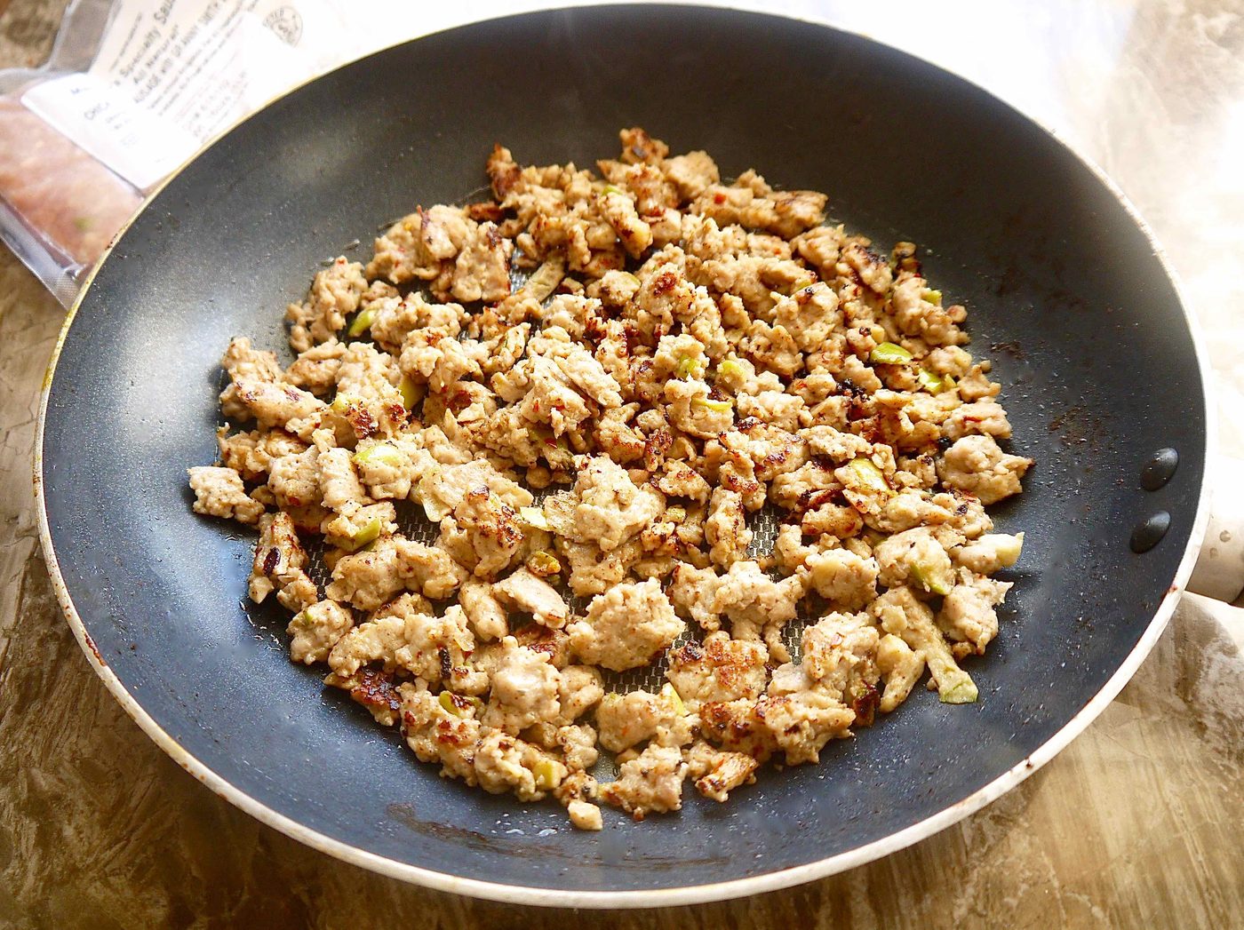 Cooked sausage in a pan.