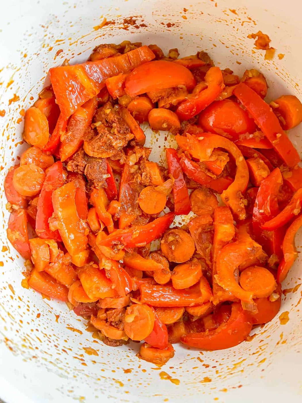 Red curry paste added to the pan.