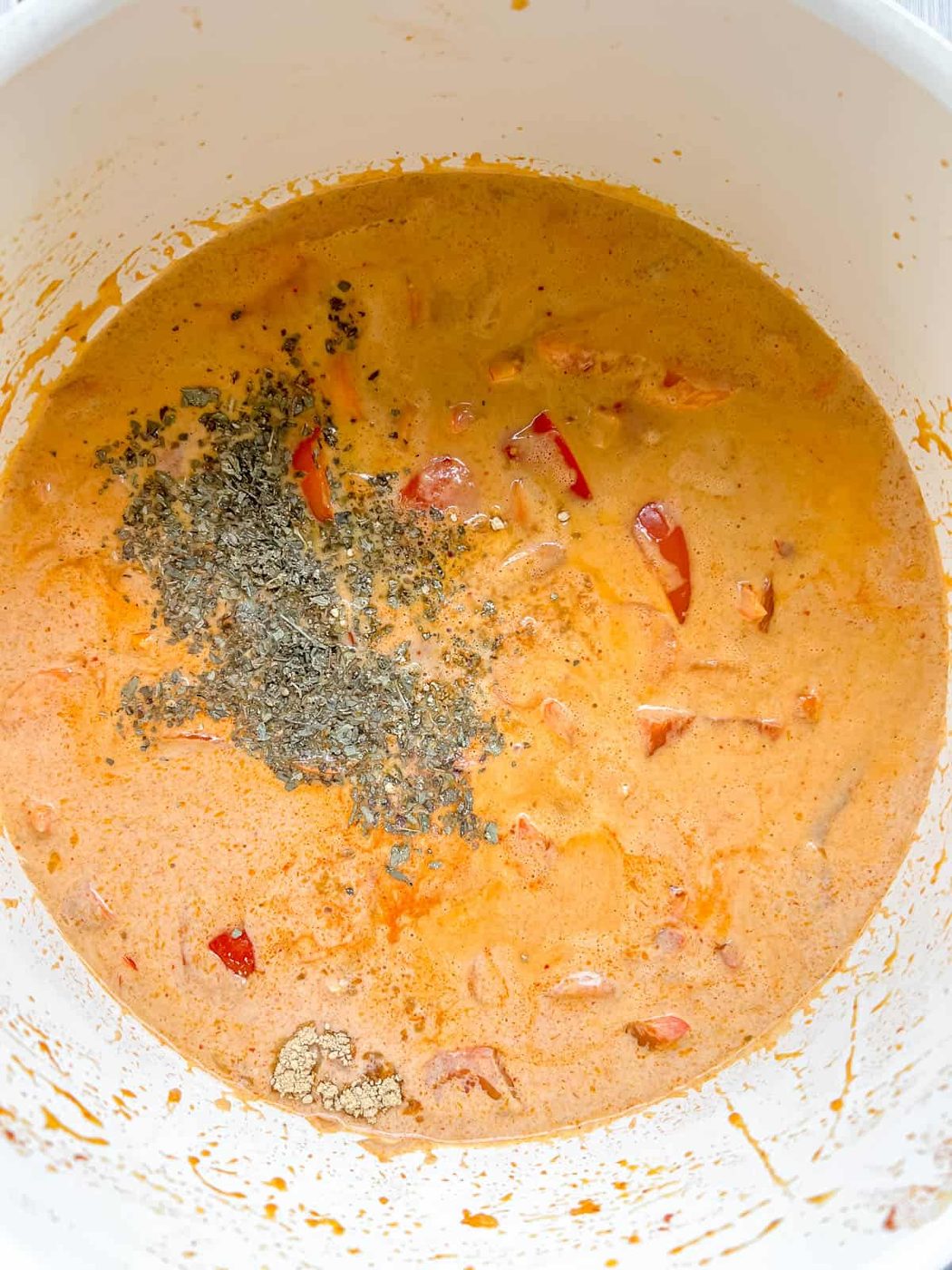 Dried basil and spices added to paleo Thai red curry.