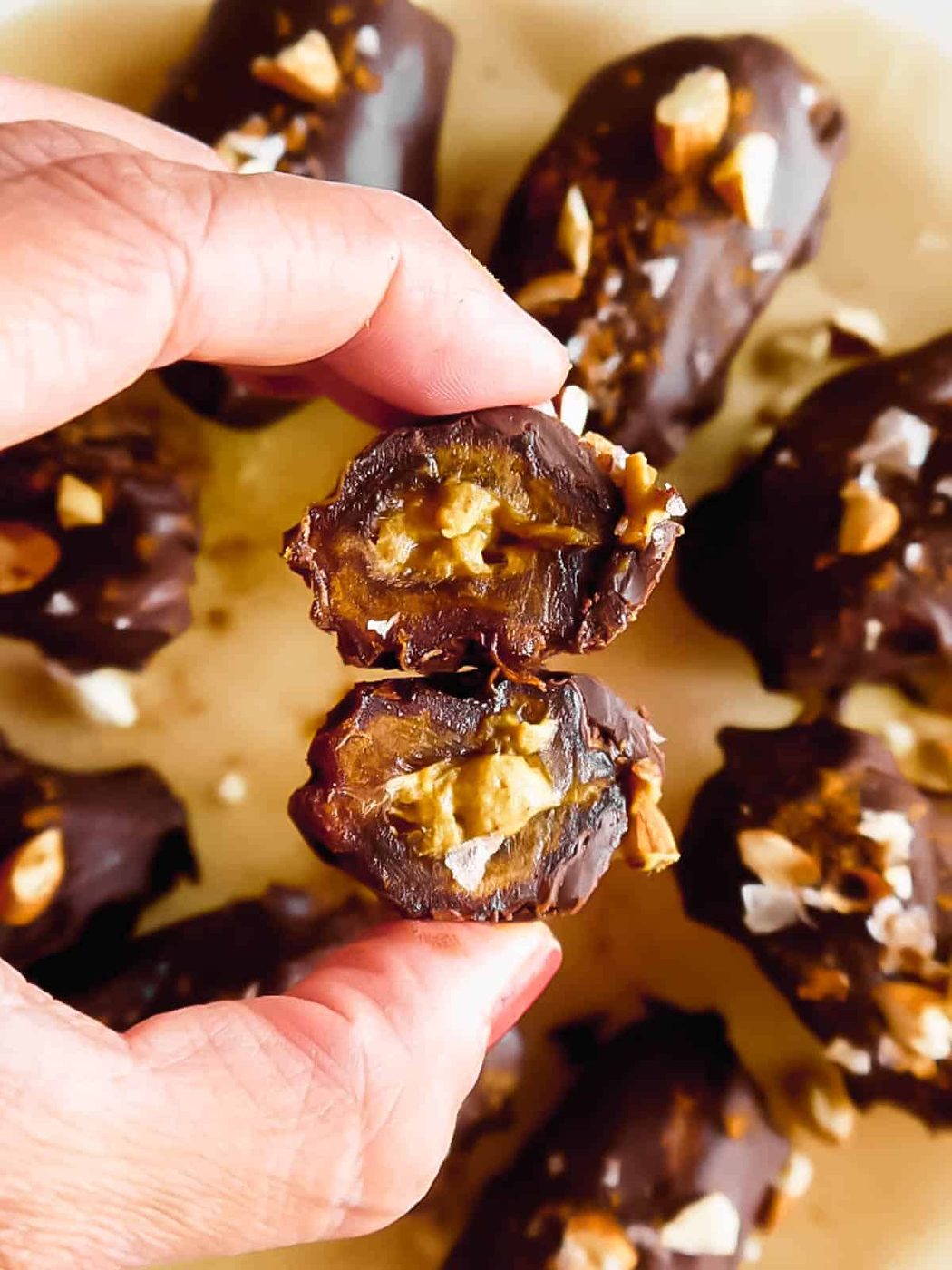 Chocolate covered dates recipe cut in half.