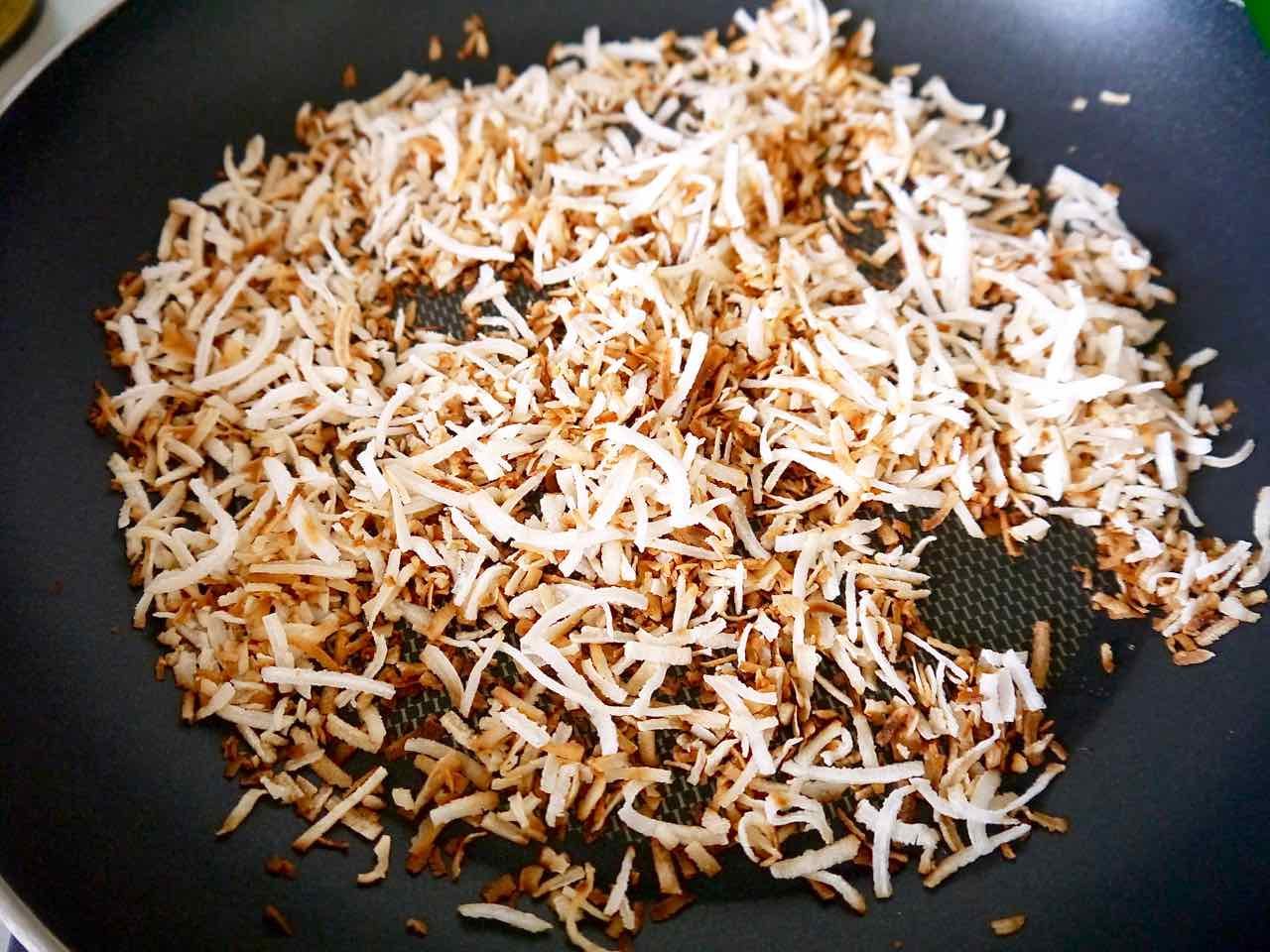 Toasted coconut on a frying pan.